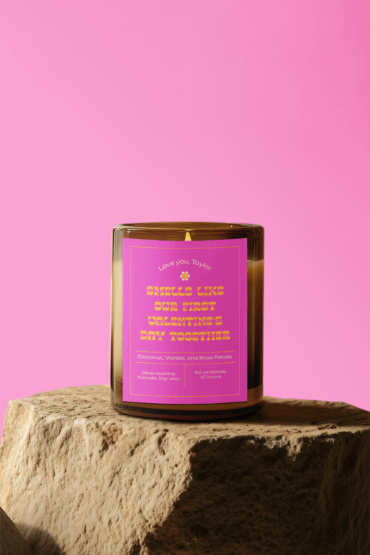 Mockup Of An Ai Generated Amber Glass Candle Placed On A Rock In A Pink Background For Valentine's Day