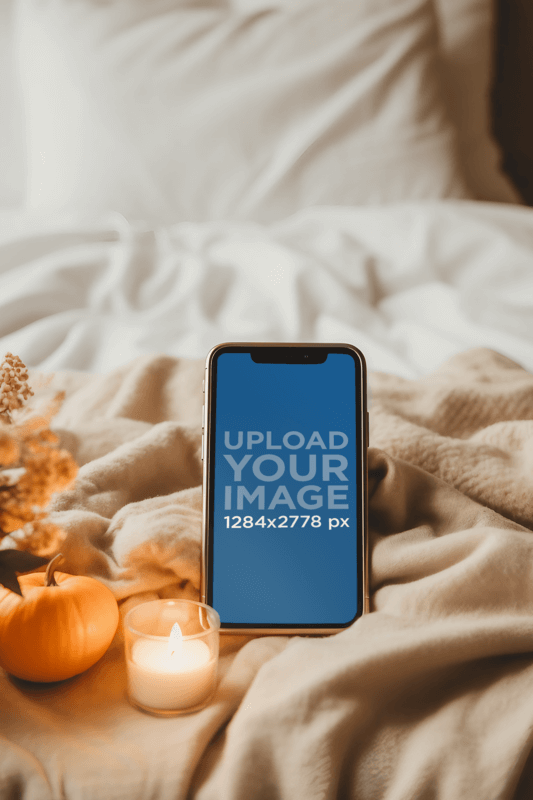 Mockup Of An iPhone Placed On A Cozy Bed Decorated With Candles Created By Placeit's AI Mockup Generator