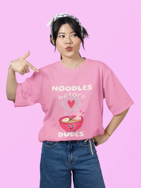 Oversized Mockup Featuring A Woman Pointing At Her Round Neck T Shirt In A Studio