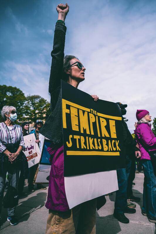 Photo Of A Woman Holding A Poster With A Feminist Quote By Pexels