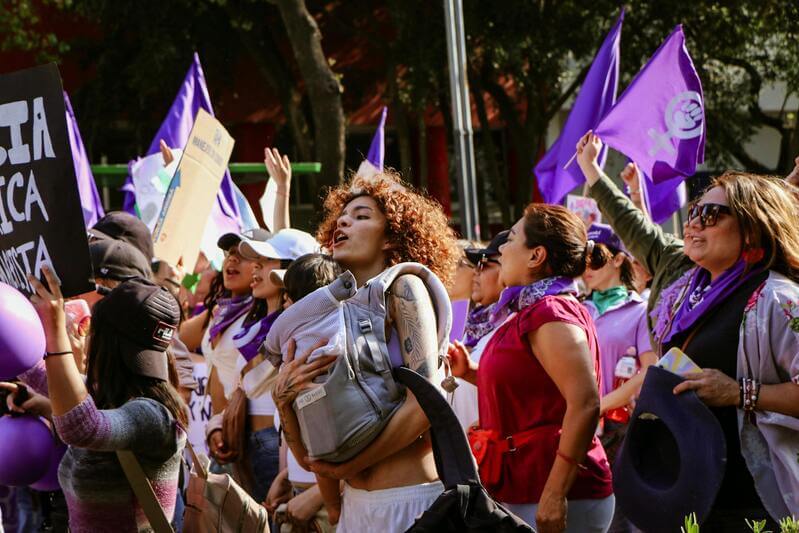 Photo Of Women Holding Signs At A Women's Day March By Pexels