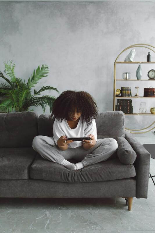 Photo Of A Gamer Playing On The Couch By Pexels