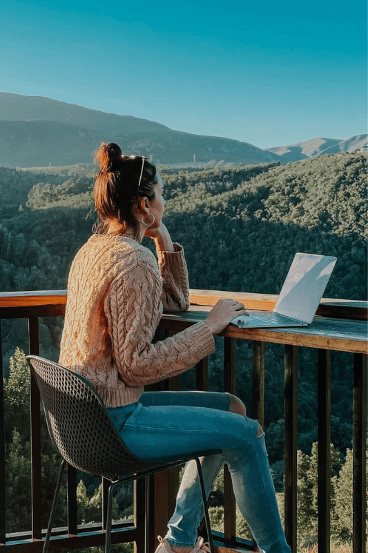 A Woman Working On Her Print On Demand Website With A Nature View