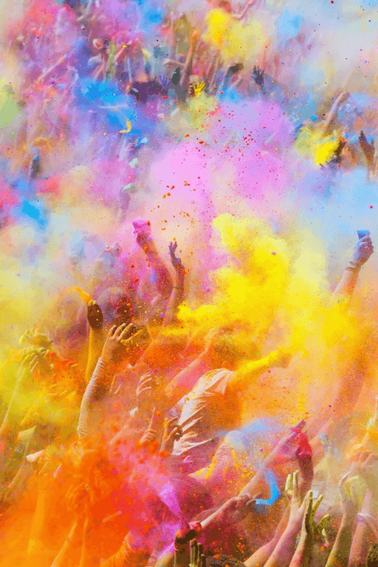 A Vibrant Celebration Where People Are Joyfully Covered In Magical And Traditional Colored Powders On Holi