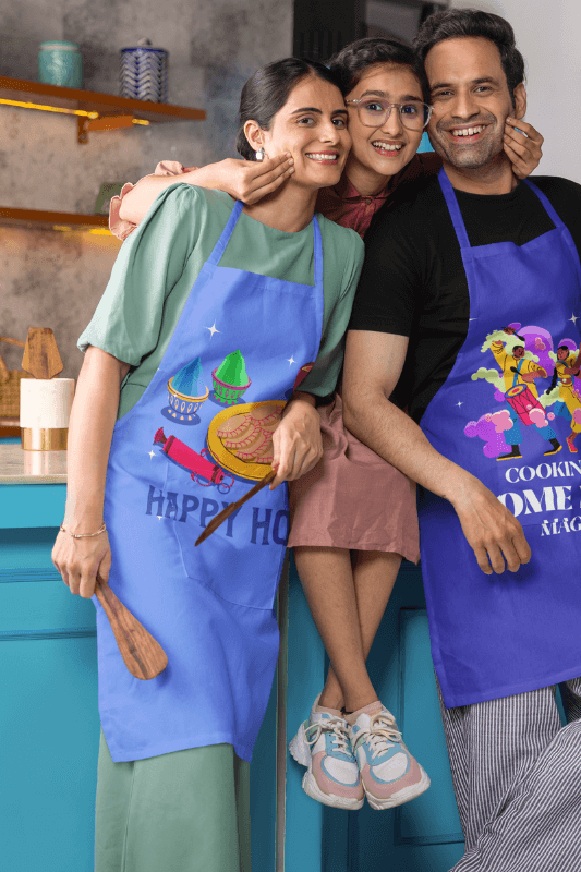 Kodenipr Club Mockup Of A Smiling Woman And A Man Wearing Aprons With Their Daughter In A Kitchen Wearing Their Gifts For Holi