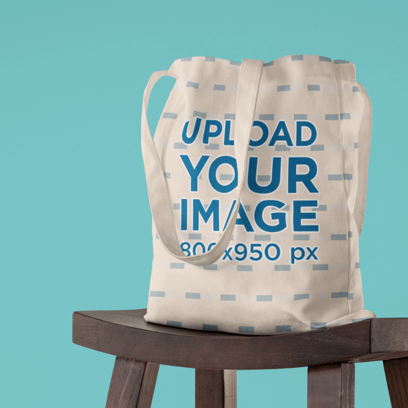 Mockup Featuring A Sublimated Tote Bag On A Wooden Stool