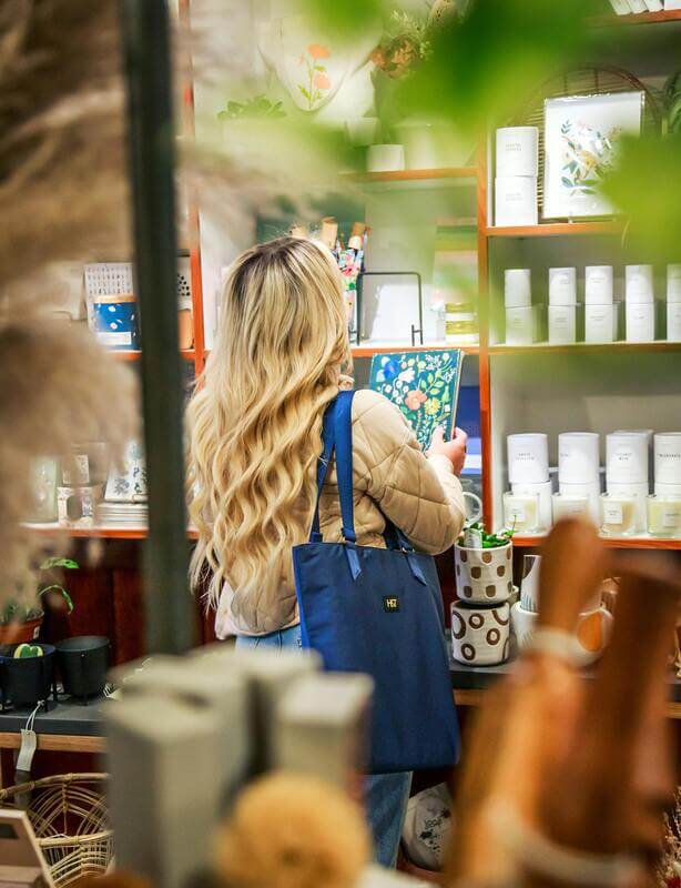 Photo Of A Woman Shopping CPG Products While Holding A Notebook By Pexels