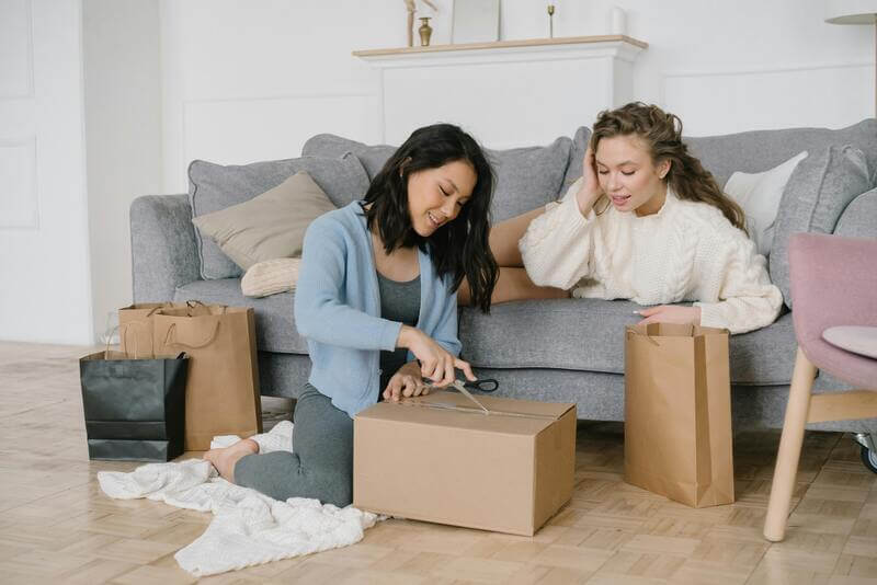 Photo Of Two Women Opening A Delivery Order By Pexels