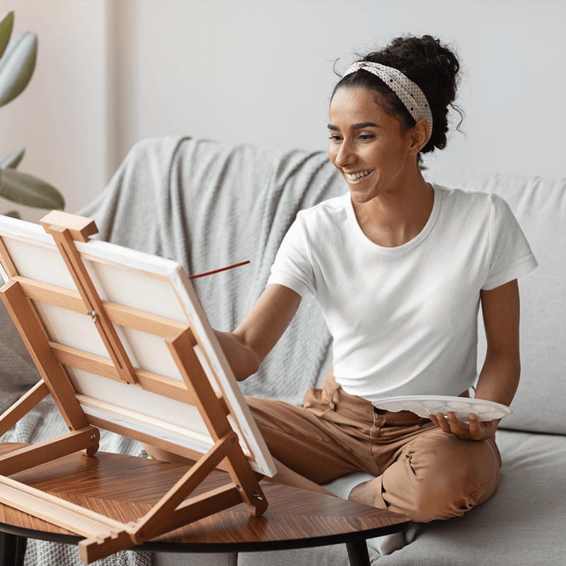 T Shirt Mockup Featuring A Woman Painting At Home Featured