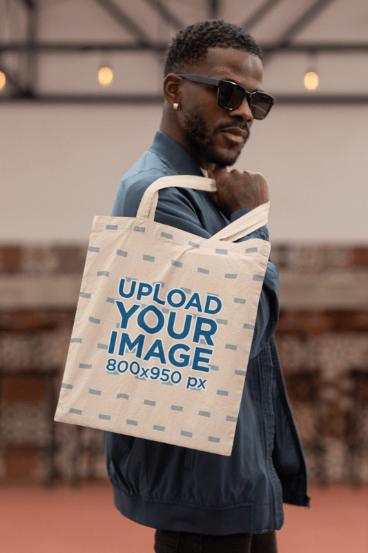 Mockup Of A Bearded Man Holding A Sublimated Tote Bag