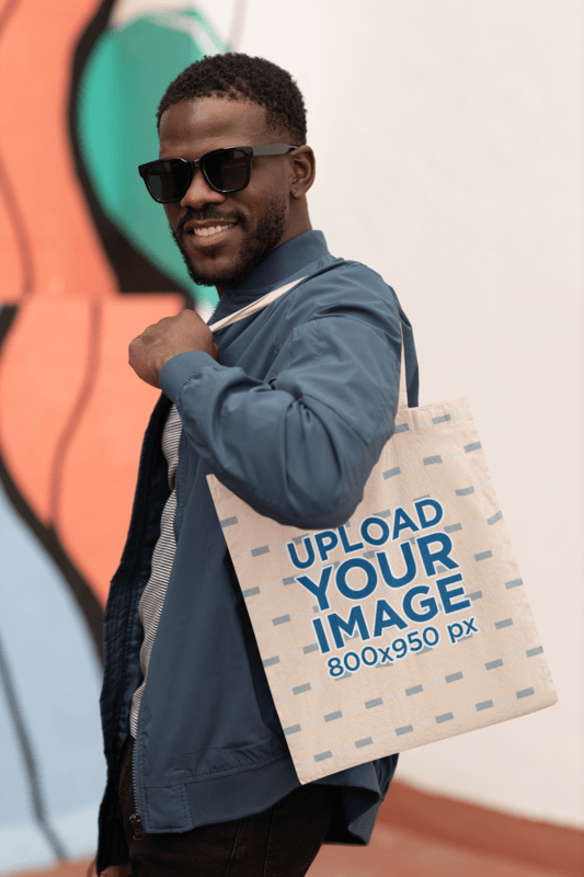 Mockup Of A Man With Sunglasses Carrying A Tote Bag On His Shoulder