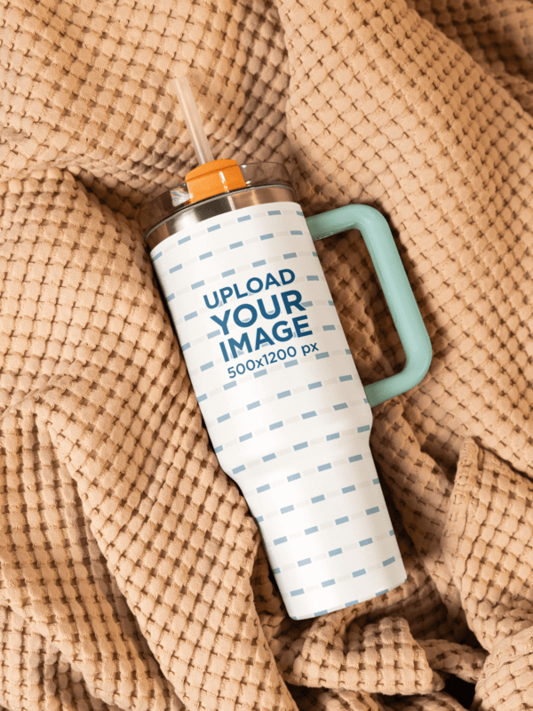 Mockup Of A Stanley Tumbler Placed On A Cozy Blanket