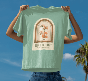 Mockup Of A Woman Holding An Oversized T Shirt Against The Sky With Palms