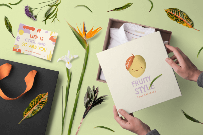 Box Mockup Featuring Flowers And A Branded Packaging Inserts For An Apparel Store