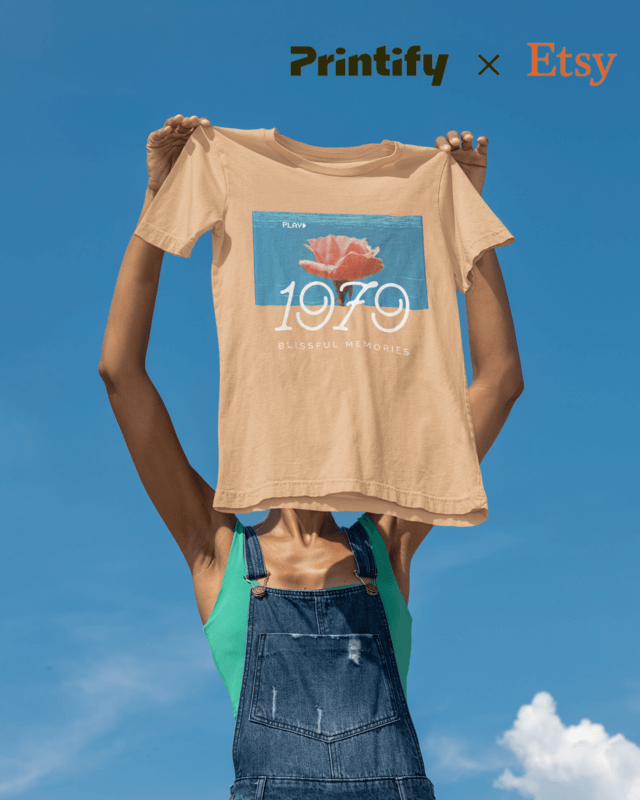Sky Shot Mockup Featuring A Woman Holding A Bella Canvas T Shirt With The Printify X Etsy Logo