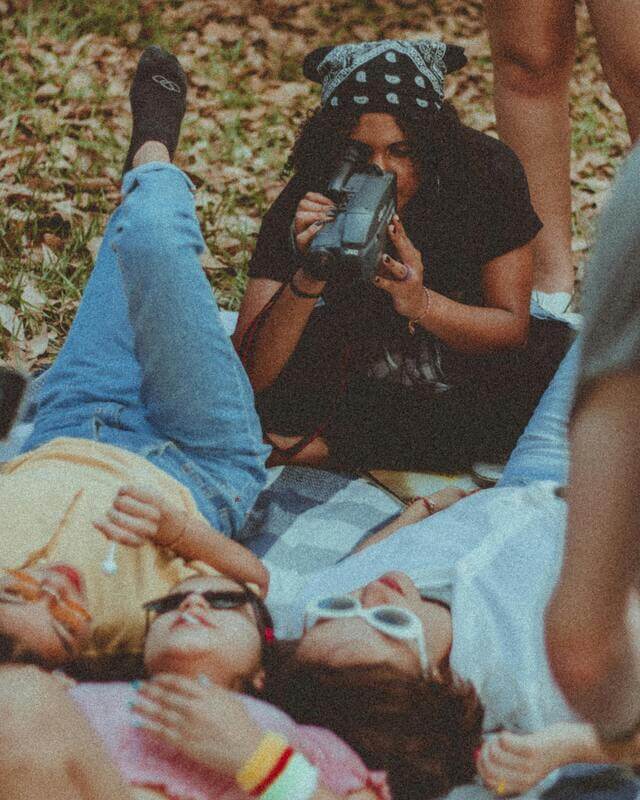 Photo Of A Woman Filming Her Friends With A Retro Style By Pexels
