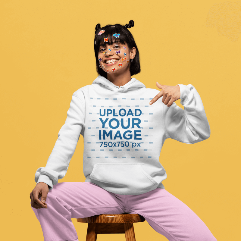 Mockup Of A Woman With Face Stickers Pointing At Her Pullover Hoodie